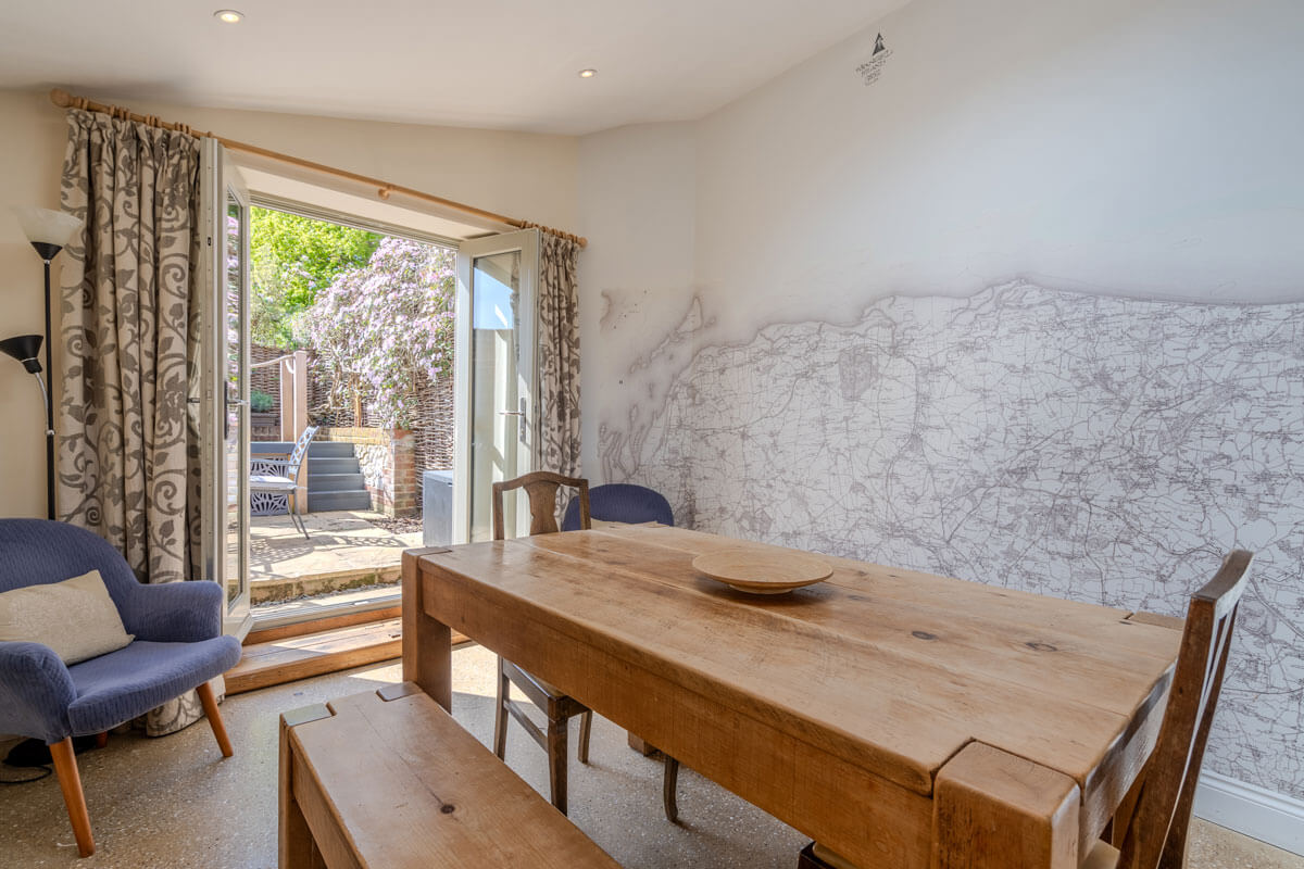 Dining area with views onto garden in holiday cottage