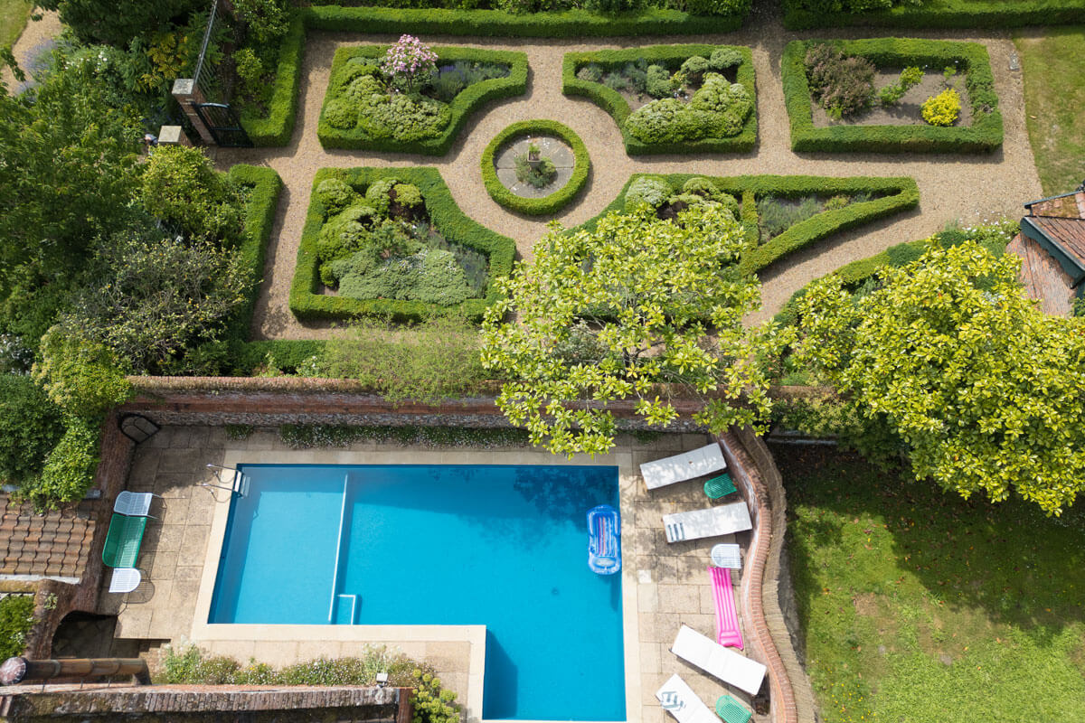 swimming-pool-north-norfolk drone photography of a swimming pool and maze in a country garden in Horstead Norfolk